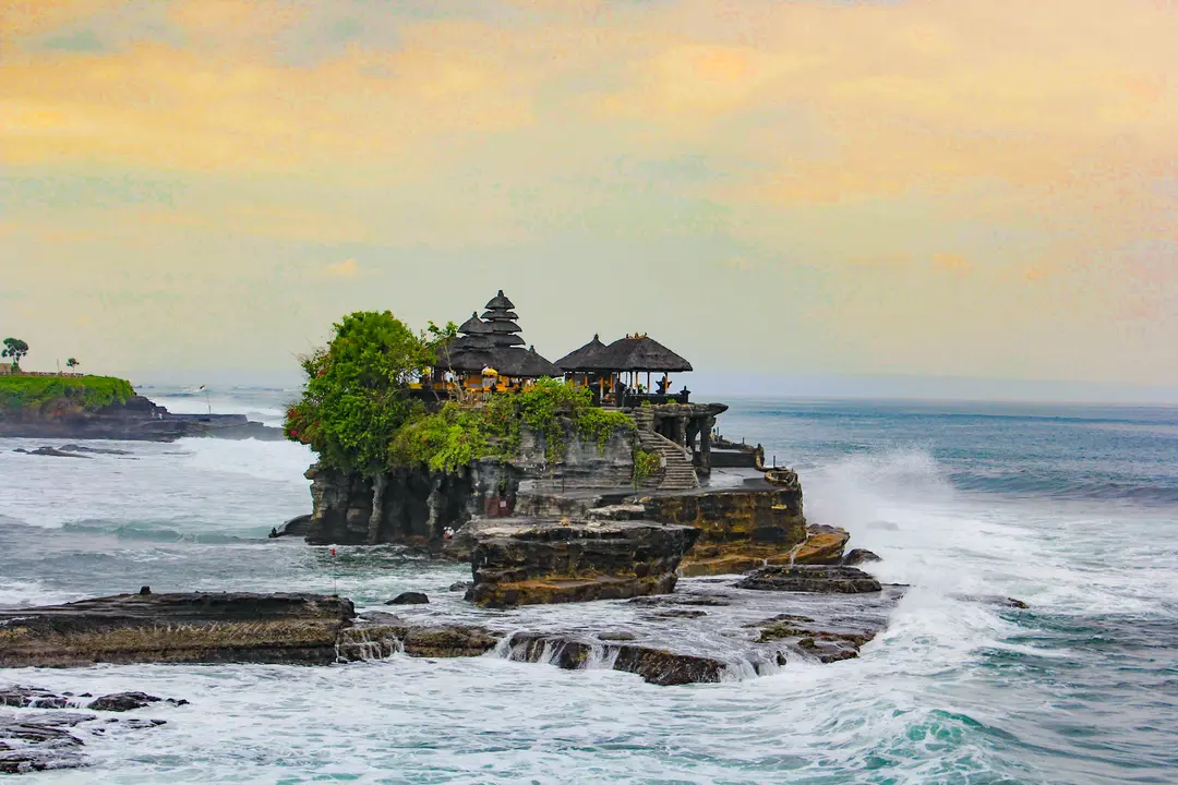 Taking a photo of Tanah Lot at sunset from the cliff top from the opposite side