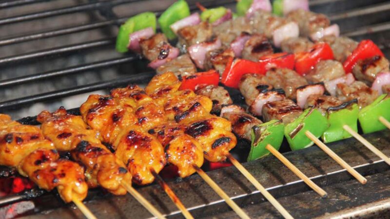 The skewer is grilled over an open flame, infusing it with a smoky, mouthwatering aroma